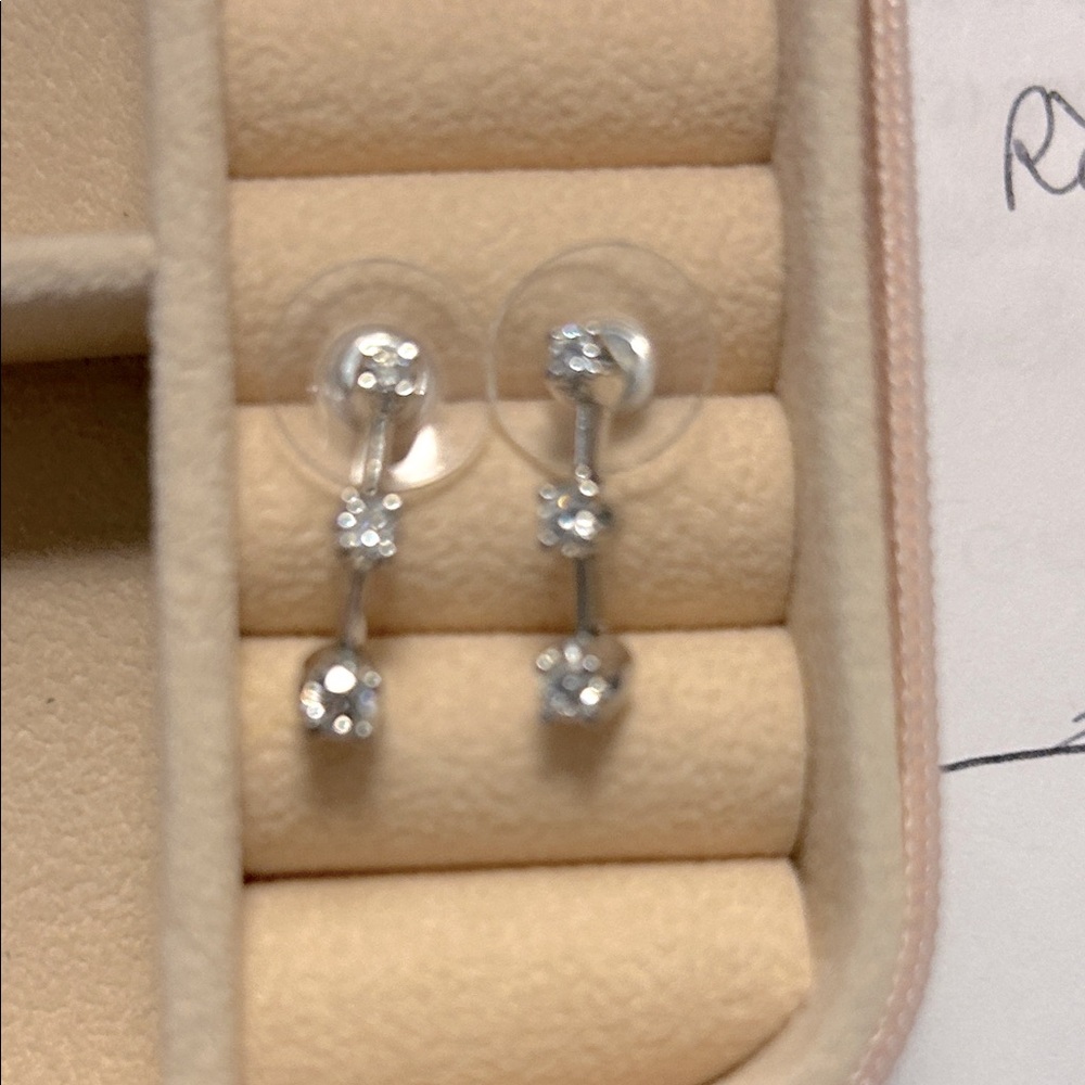 Kay Jewelers past, present and future diamond earring set in white gold.